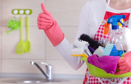 Cleaning staff sanitising a kitchen and break room in an E11 office